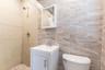 Bathroom featuring tile walls, tiled shower, and vanity