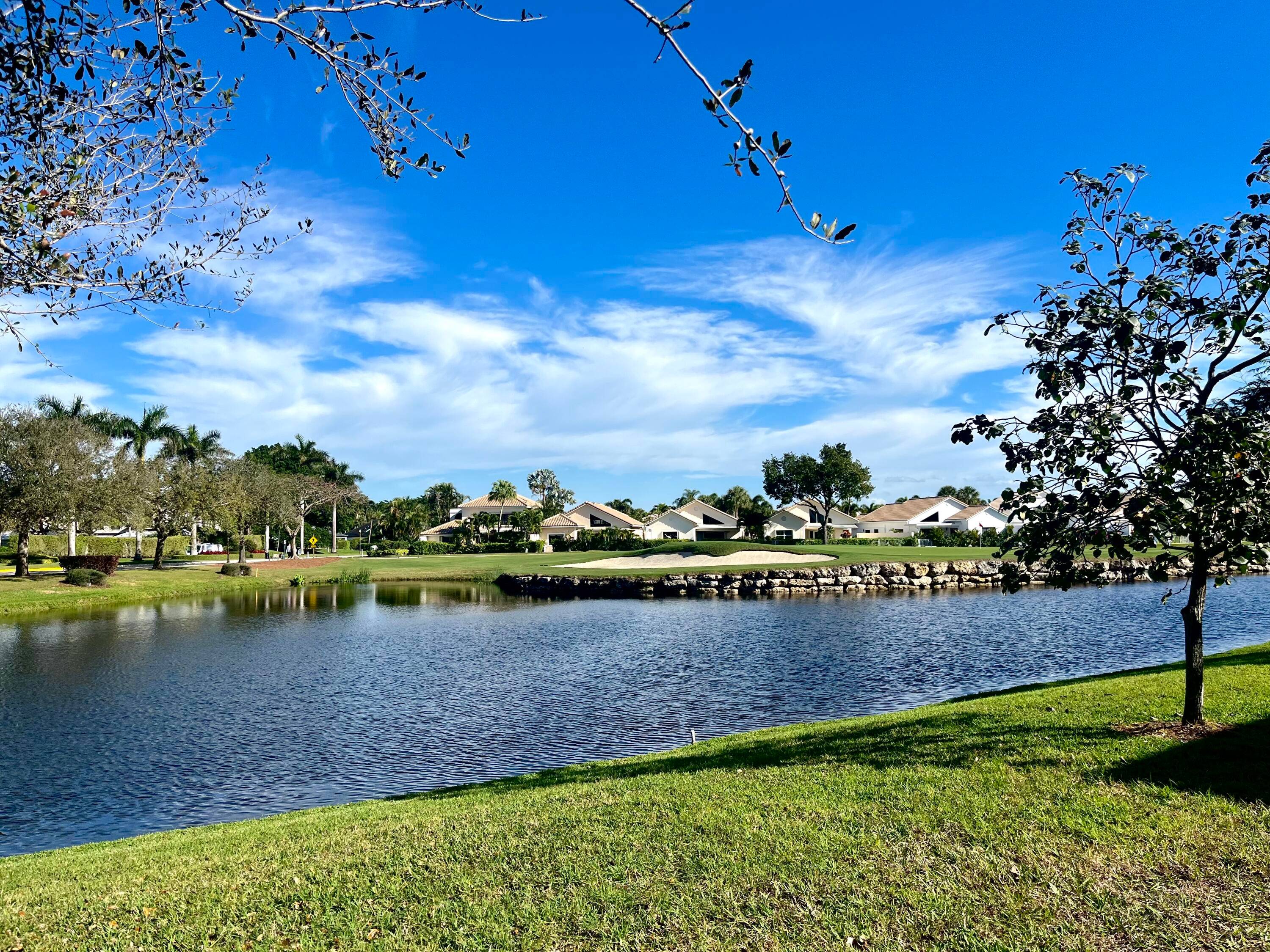 Experience luxury living in this fully renovated first floor condo, boasting a prime location overlooking both the serene lake and lush golf course.