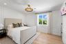 Bedroom featuring a decorative wall, light wood finished floors, and recessed lighting