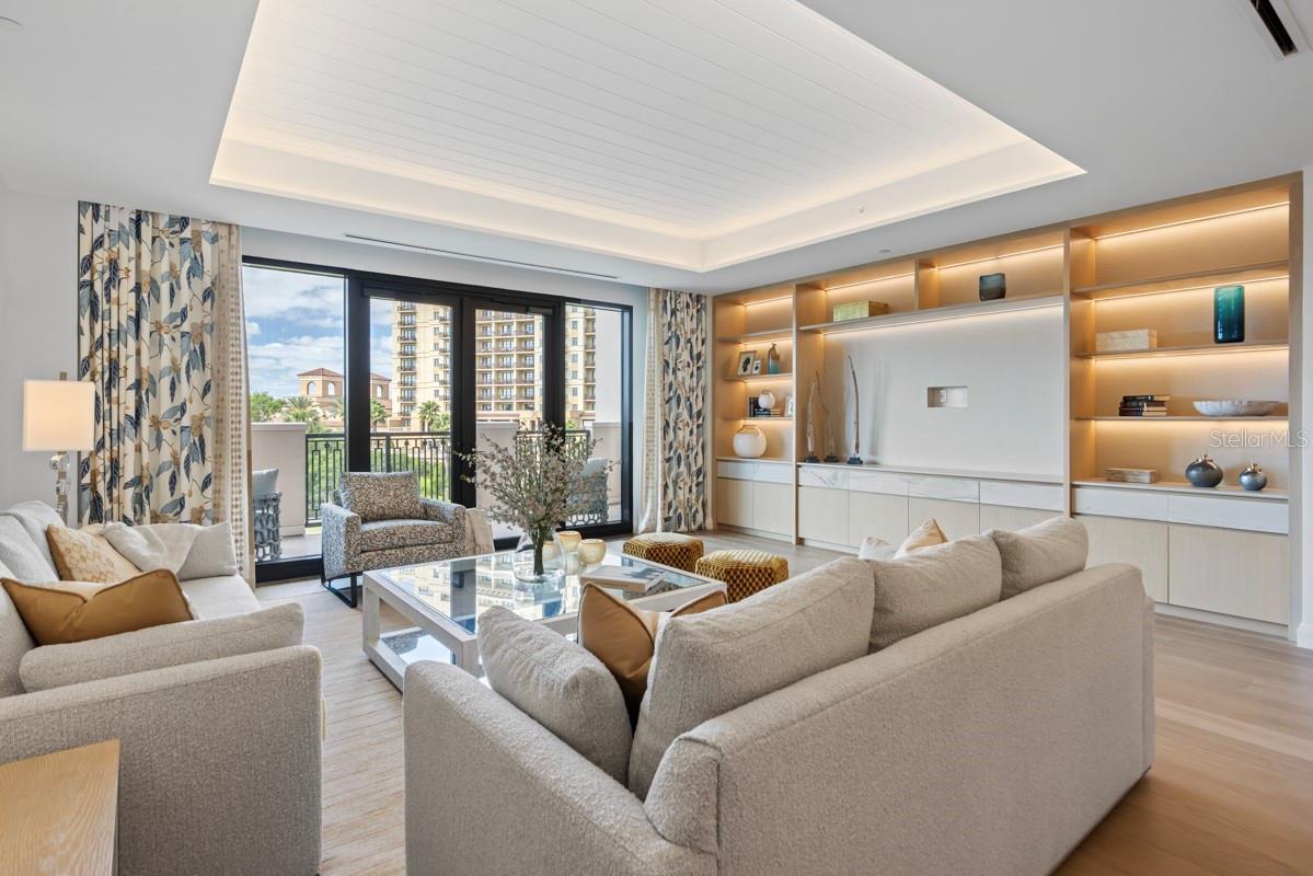 Spacious open concept living room with tongue and groove ceiling details and lighting