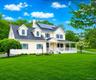 Inviting Colonial with wrap-around front Porch at the end of a cul-de-sac on over an acre