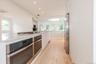 Kitchen with white cabinetry, modern cabinets, light wood-type flooring, recessed lighting, and a spacious island