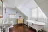 Charming upstairs bathroom with classic clawfoot soaking tub