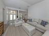 The formal living room is large and bright