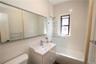 Full bath featuring shower / bathtub combination, vanity, and tile walls