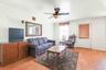 Living area with light wood-type flooring and a ceiling fan