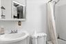 Full bathroom featuring shower / bath combination with curtain, sink, and toilet