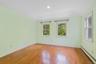 Unfurnished room with a baseboard heating unit, light wood-type flooring, and recessed lighting