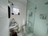 Full bathroom featuring a shower stall, wooden walls, and tile patterned floors