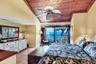 Warm & Inviting Primary Suite with Terracotta Tile, Wood Ceiling Detail, and Private Patio with Full Bay View