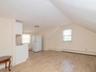 Bonus room featuring light wood finished floors, vaulted ceiling, and a baseboard heating unit