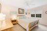 Bedroom featuring light carpet and ceiling fan