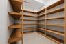 Custom shelving system with wood-finish construction providing extensive storage