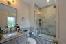 Full bathroom featuring vanity, toilet, and enclosed tub / shower combo