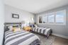 Bedroom featuring baseboards and wood finished floors