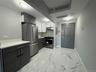 Kitchen featuring stainless steel appliances, modern cabinets, white cabinetry, light marble finish floors, and decorative backsplash