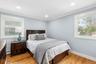 Bedroom featuring light wood-style floors, crown molding, recessed lighting, and a baseboard heating unit