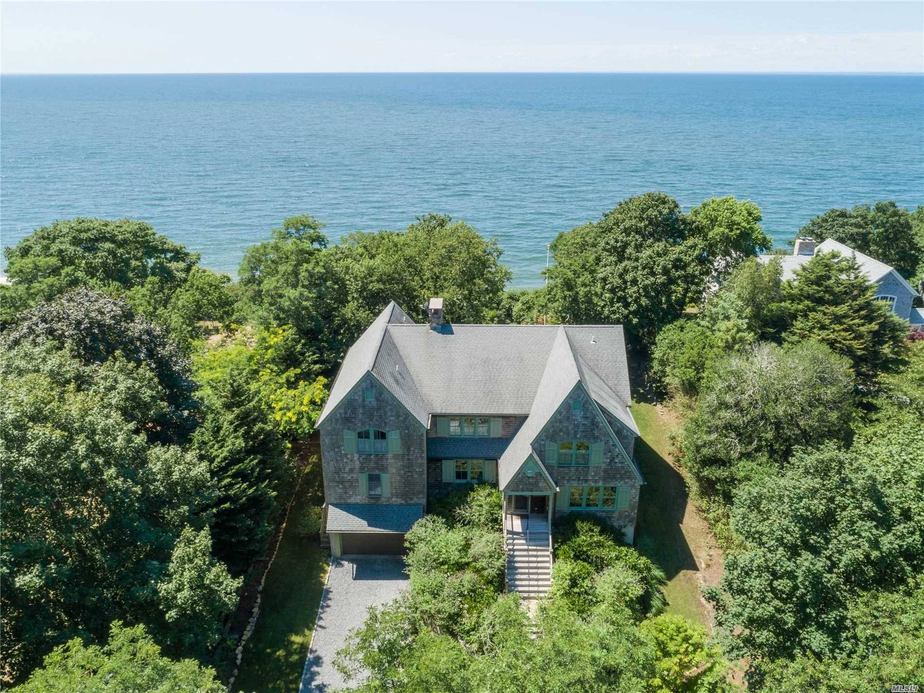 Down a winding country lane high on a bluff is this majestic 6365 sf sound front home with panoramic views to Connecticut.