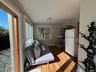Living area with baseboards and dark wood-style flooring