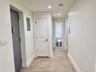 Hallway featuring electric panel, wood-like tiled floors, and recessed lighting