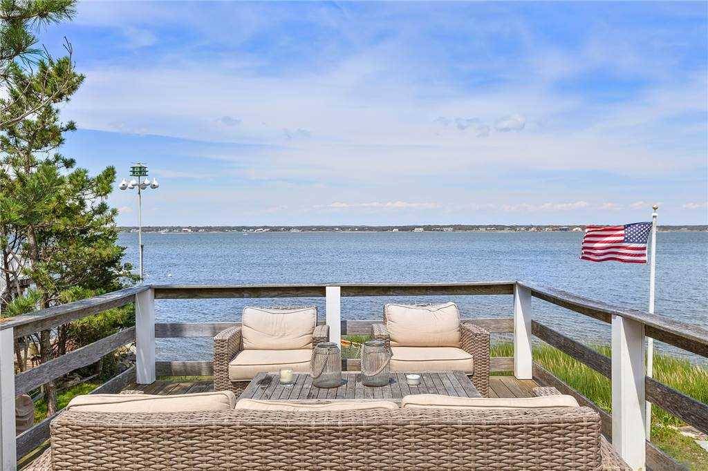 Enjoy this updated Dune Road beach house, with stunning views of Moriches Bay !
