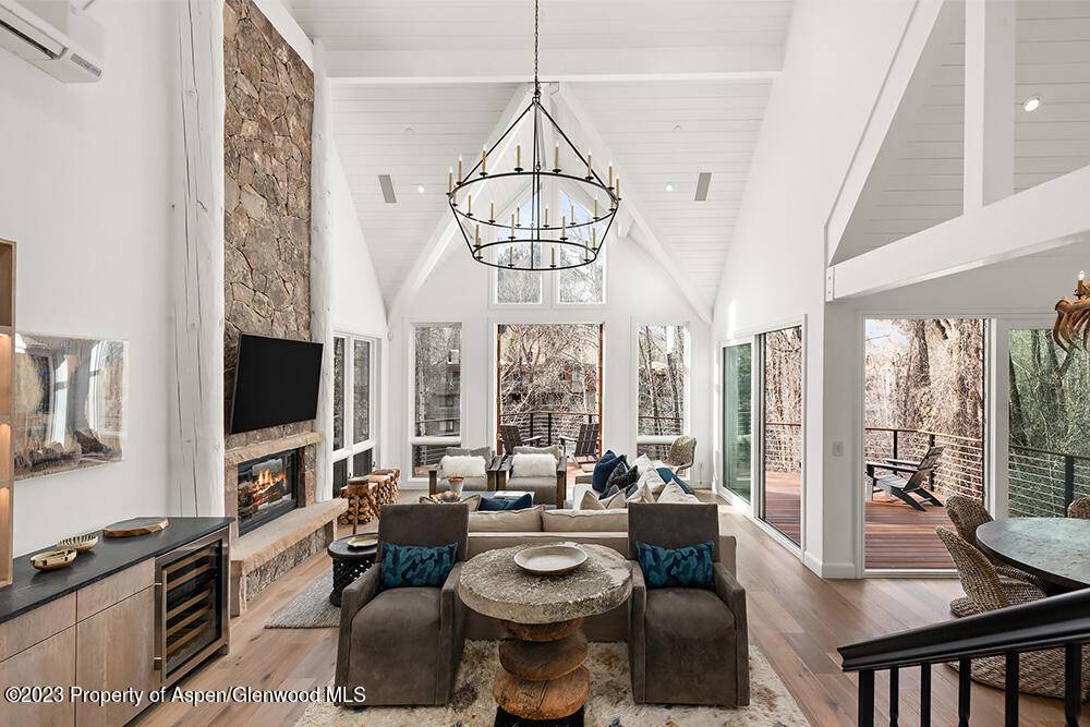 Beautiful contemporary mountain house with almost 4000 sq ft of indoor living space sitting sublimely on the Roaring Fork River and still easily walkable to downtown Aspen.