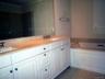 Primary Bath offers a double sink vanity with marble counter tops... plenty of storage...