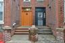 Brick exterior featuring contrasting entry doors