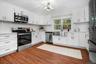 Sleek quartz counters and stainless steel appliances highlight the fresh, modern design of this fully renovated kitchen.