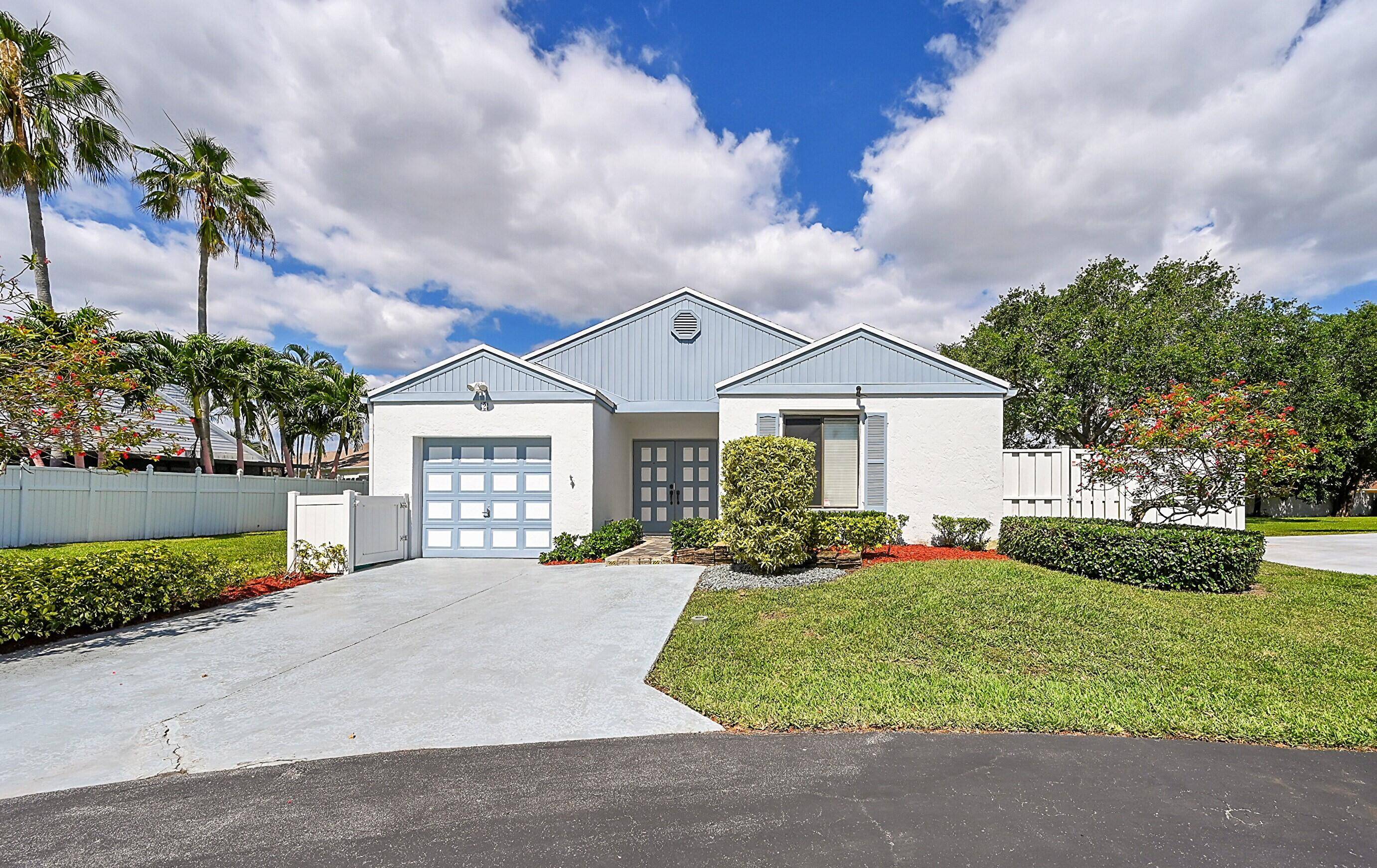 This beautiful 3 bedroom, 2 bath single family home is nestled upon a large grassy corner of a quiet Cul de Sac in the ever popular Boynton Lakes community.