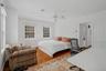 Bedroom with hardwood / wood-style floors and ceiling fan