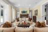 Living area with crown molding, wood finished floors, a wainscoted wall, a decorative wall, and recessed lighting