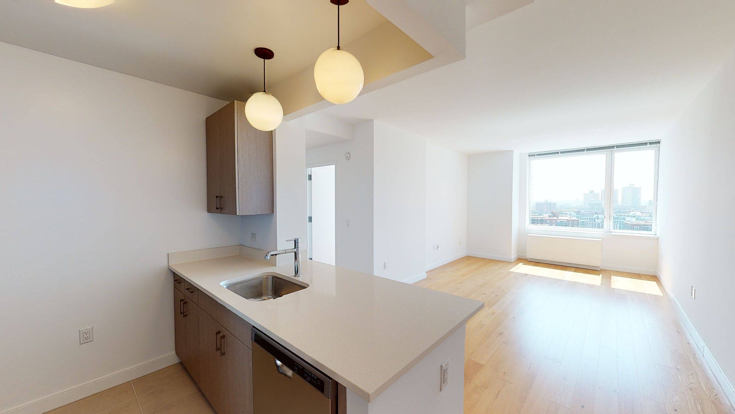 Spacious 1 bedroom plus home office with open gourmet kitchen featuring stainless steel appliances, Caesarstone quartz counters, and eating bar.