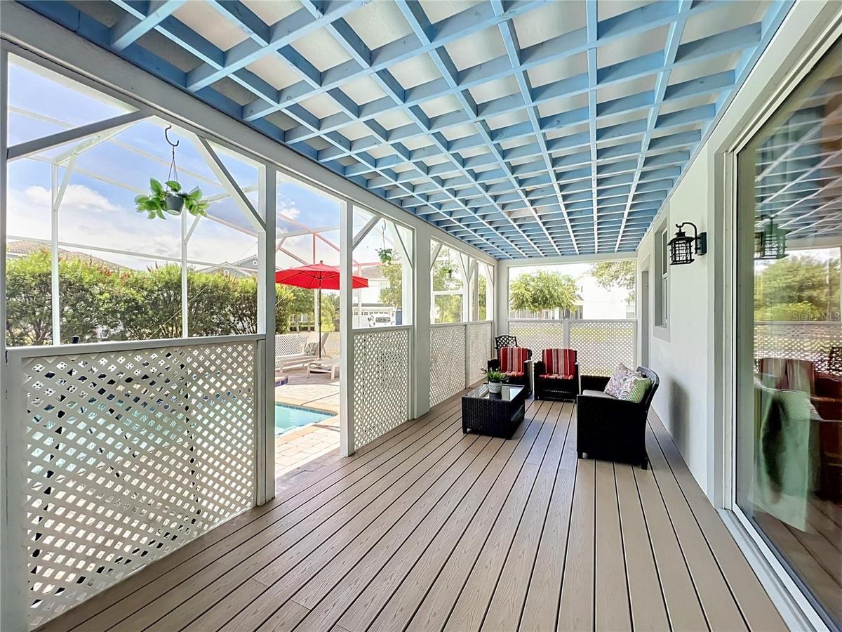 Covered lanai with upgraded wood flooring / wood ceiling accents.