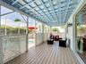 Covered lanai with upgraded wood flooring / wood ceiling accents.