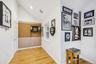 Hallway featuring vaulted ceiling, light wood-style flooring, and recessed lighting