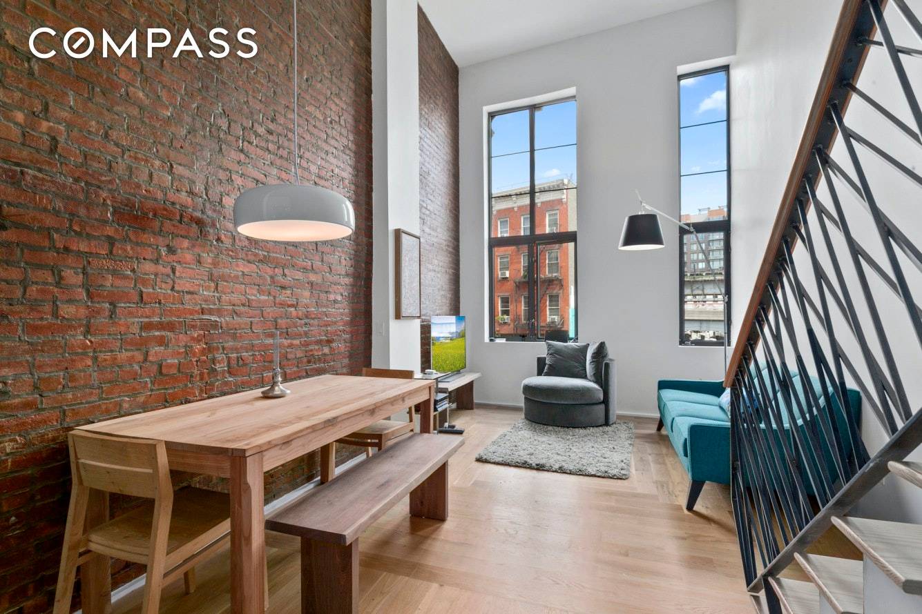 Originally built in 1920 and converted to condo in 2015 this duplex offers soaring 17 foot ceilings and a full wall of original exposed brick.