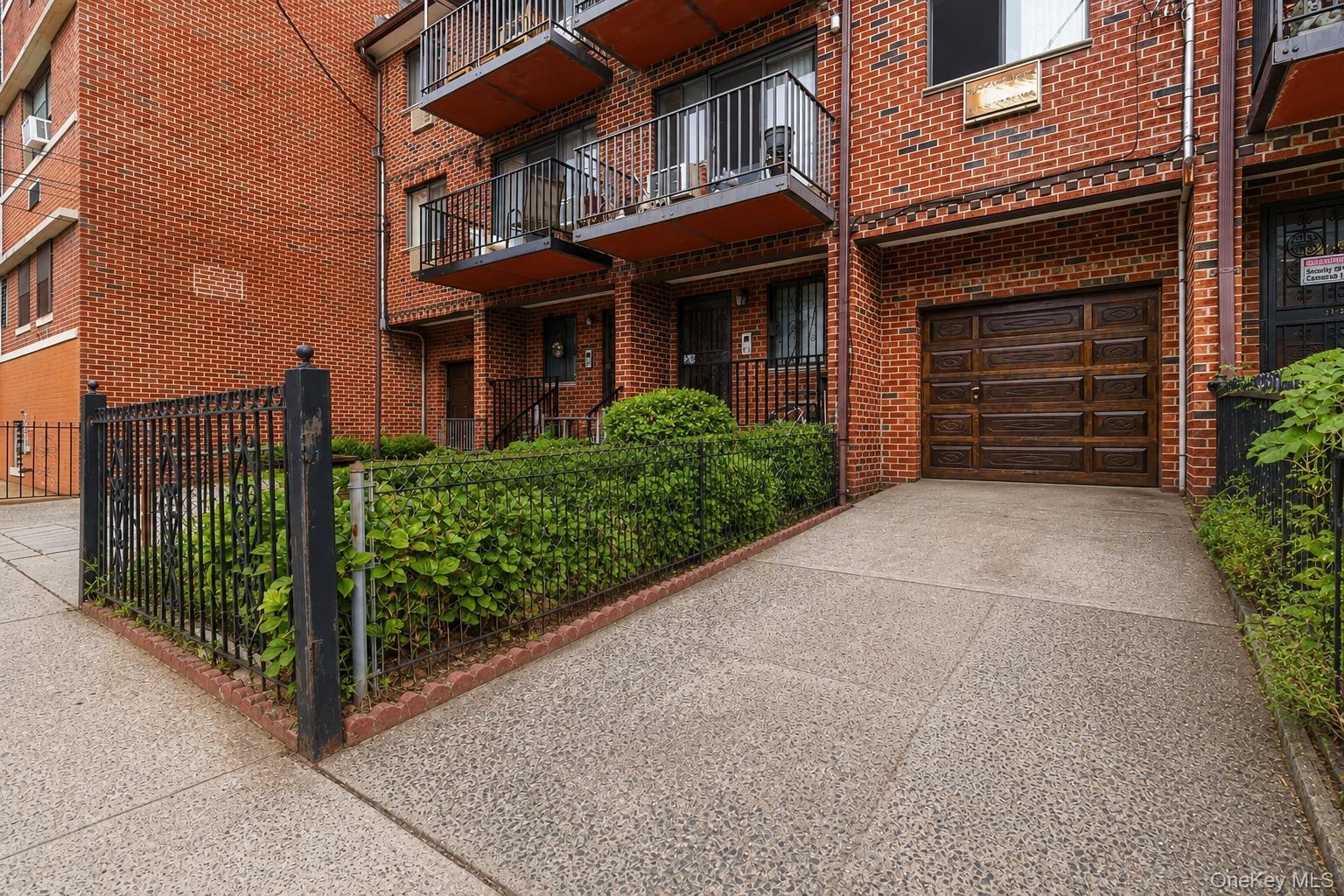 Brick three-family residence with private driveway and attached garage.