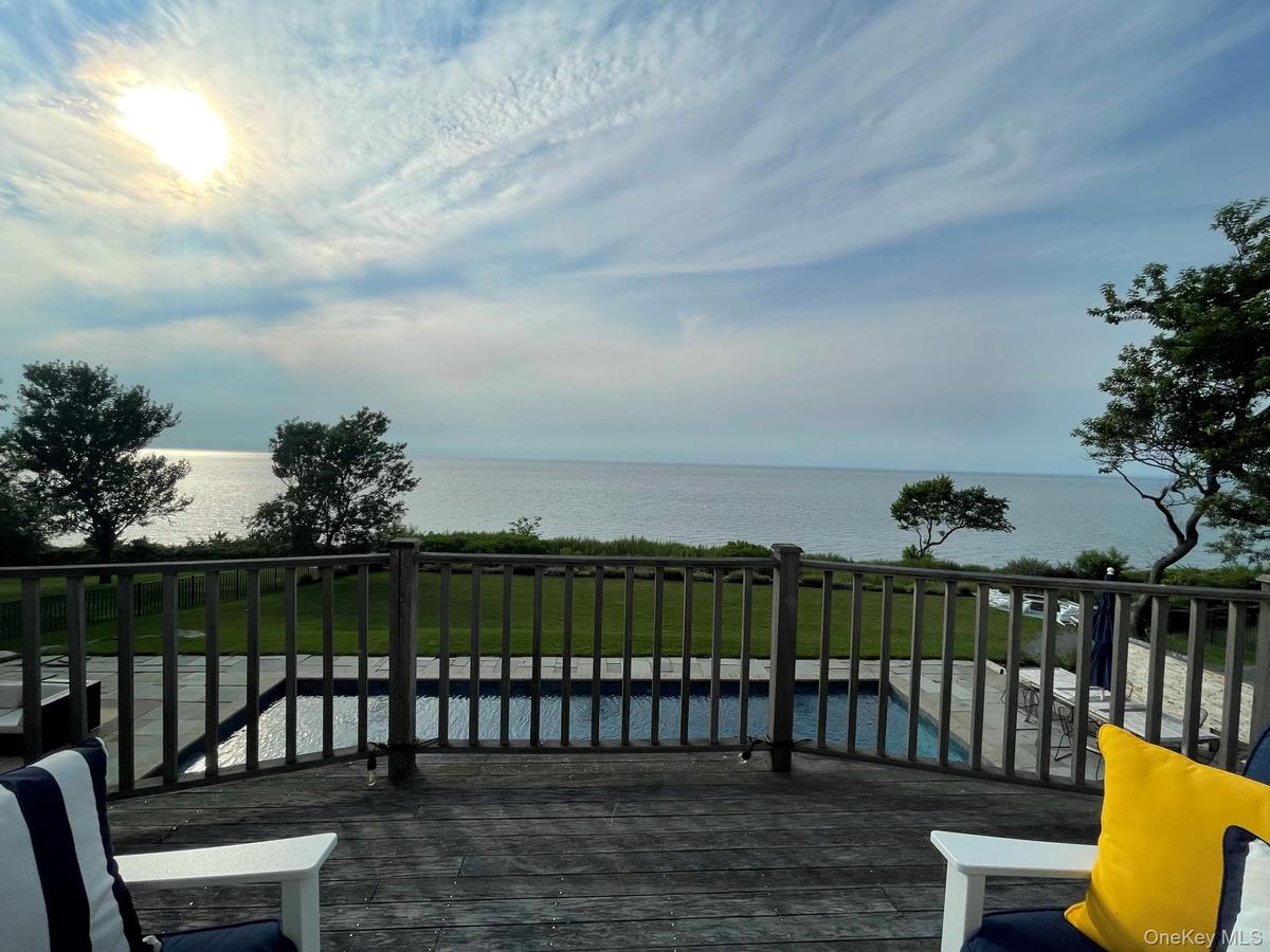 Deck featuring a water view and a lawn
