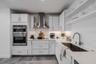 High-end stainless-steel appliances include a French door refrigerator, dishwasher, double wall ovens, and a vent hood. Large tile floors and under-c