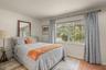 Guest bedroom with abundant natural light and scenic views of the surrounding landscape
