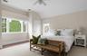 Bedroom featuring baseboards, vaulted ceiling, visible vents, and a ceiling fan