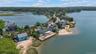 Aerial perspective of suburban area featuring a nearby body of water