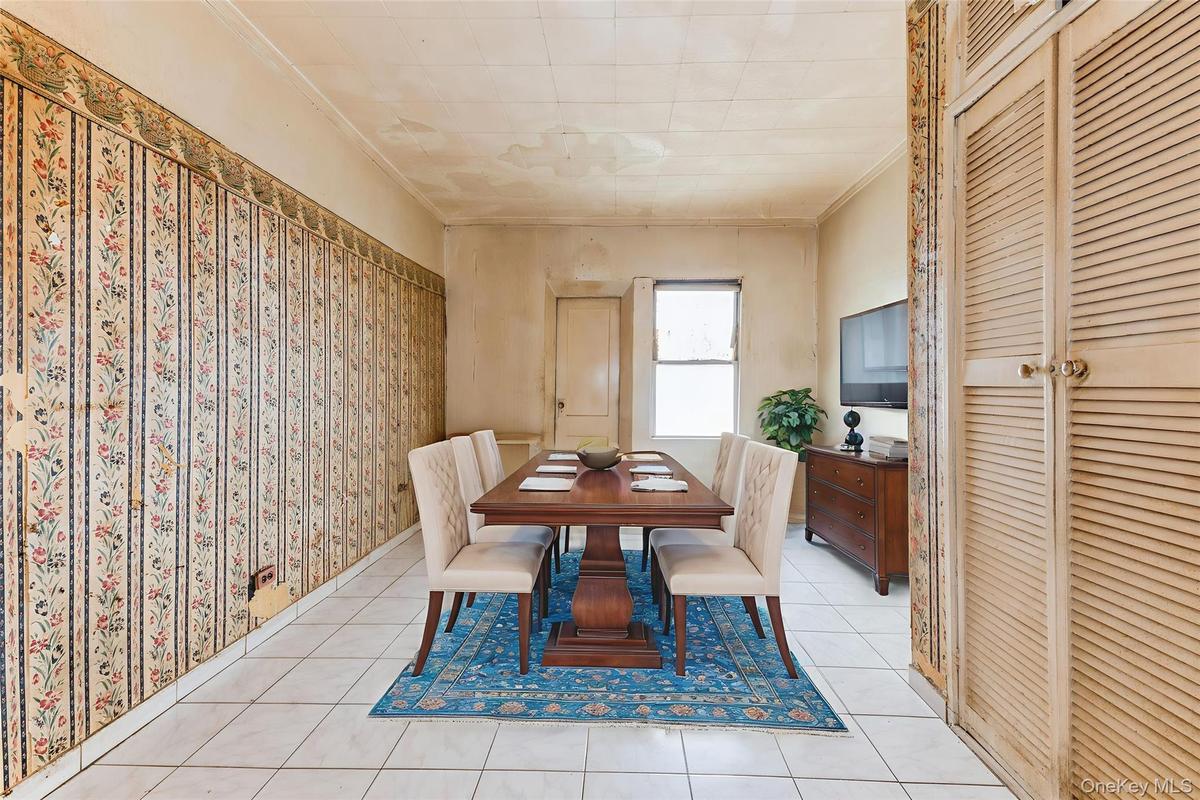 Dining area featuring crown molding and light tile patterned floors