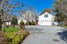 Frontal exterior view with gated entrance from circular driveway to private resort like backyard