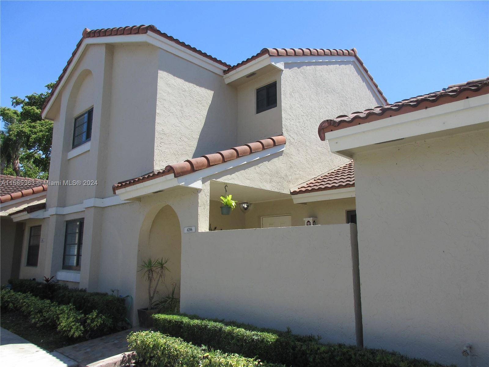 Welcome home ! This well maintained, two story townhome is located on a canal lot in The Moors, a gated community just north of Miami Lakes.