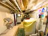 Basement with tile patterned floors and water heater