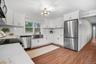 Beautifully renovated kitchen with an open layout, quartz countertops, and stainless steel appliances creating a bright and functional gathering space