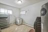 Laundry area with baseboard heating and water heater