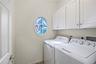 Washroom with cabinet space and washing machine and dryer